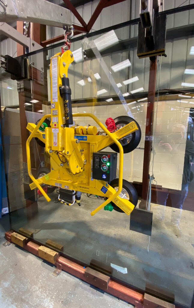 ODC Poole factory spider crane with pane of glass