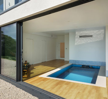 Sliding doors lead into the swimming pool room