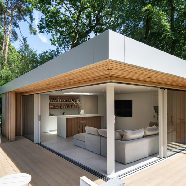 Corner opening sliding doors with white frames for garden room