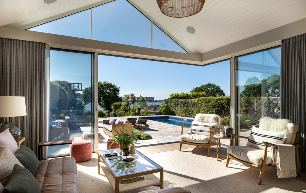 Open glass corner sliding doors for poolside inside/outside living space