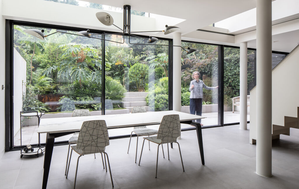 Victorian house ground floor transformed by renovation using sliding glass walls 