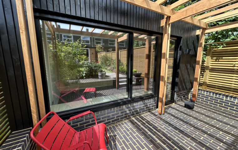 front facade of garden room showing black sliding room